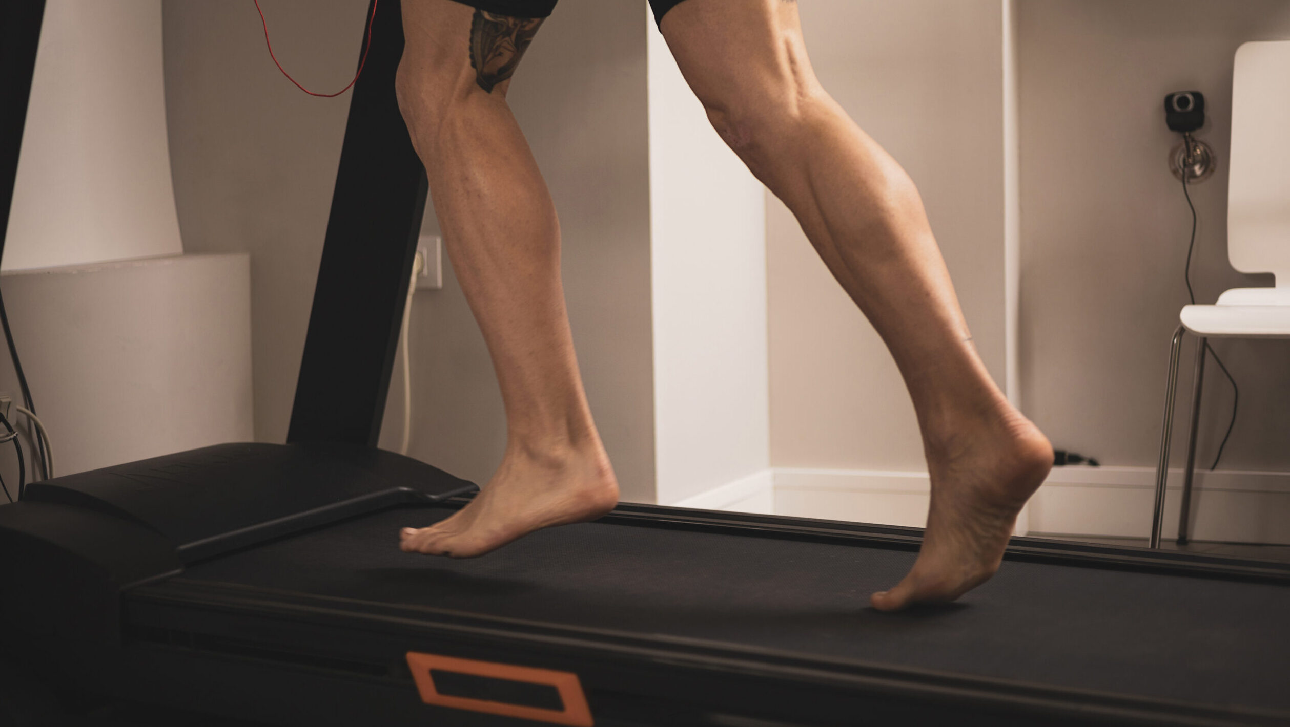 An athlete runs on a treadmill for a gait study.biomechanical study of the foot.