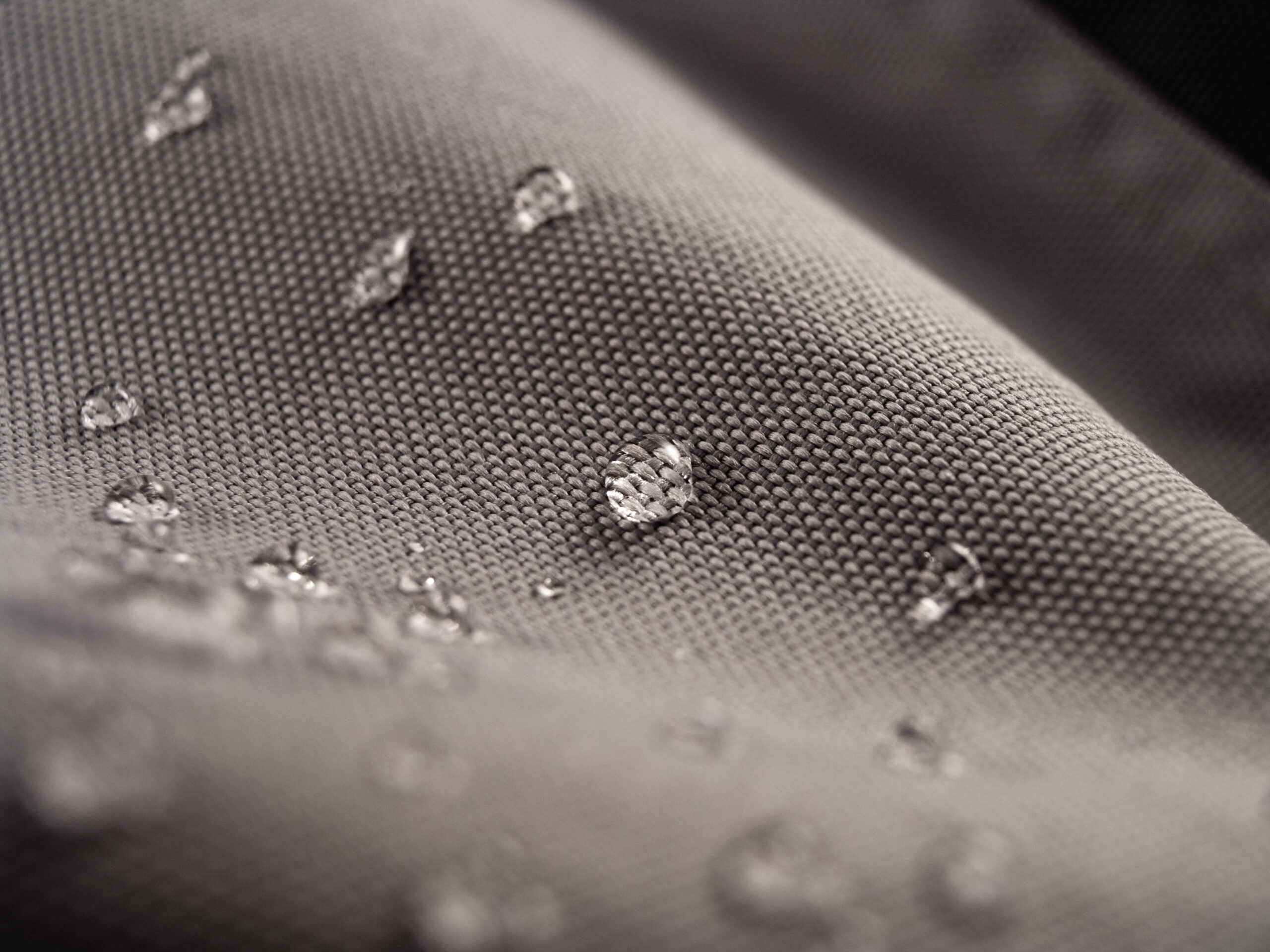 Macro shot of water rain drops on waterproof textile jacket. Extreme depth of field. Please visit my portfolio for different shots of this subject.